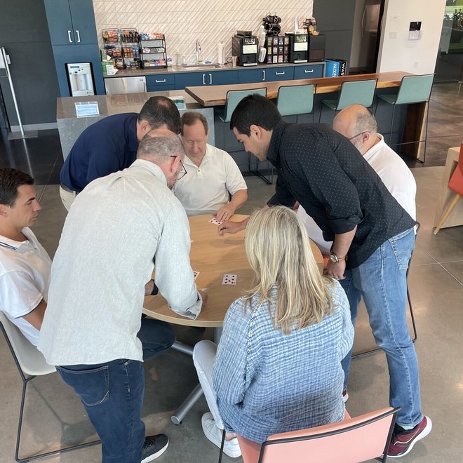 A leadership team huddled around a table during a working session